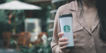 A woman with a Starbucks cup.