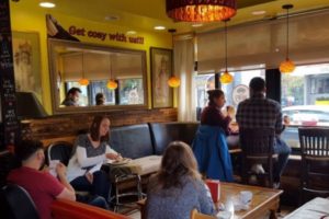 A group of people eating at a restaurant table.