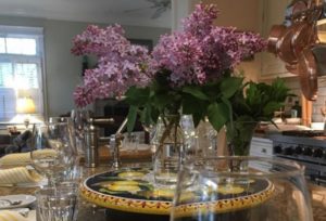 Flowers in a vase on a dinner table.