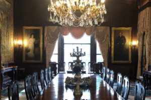 Dining table, chairs and a chandelier.