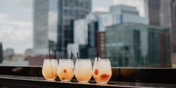 Four drinks and rooftop view