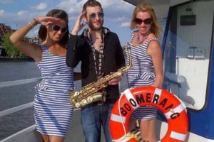 A saxophone player and two women