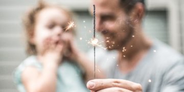 Man with toddler and sparkler