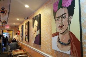 Tables and portraits on the wall at a restaurant
