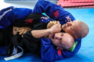 Two men practicing jiu-jitsu. 