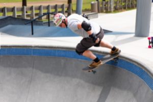 A man skating over a ramp.