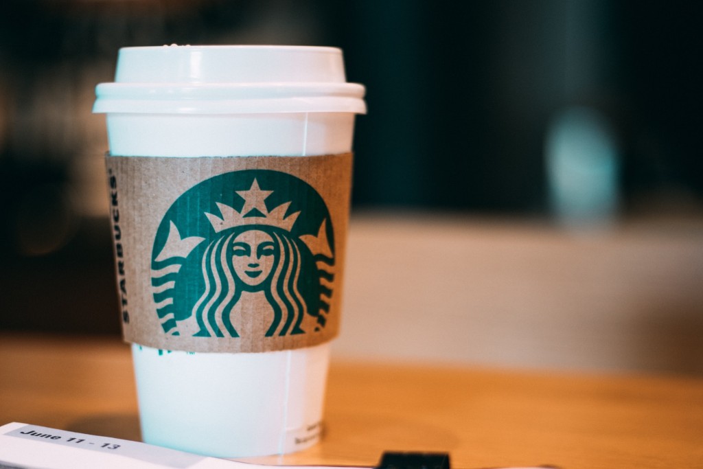 A white plastic cup with the Starbucks logo