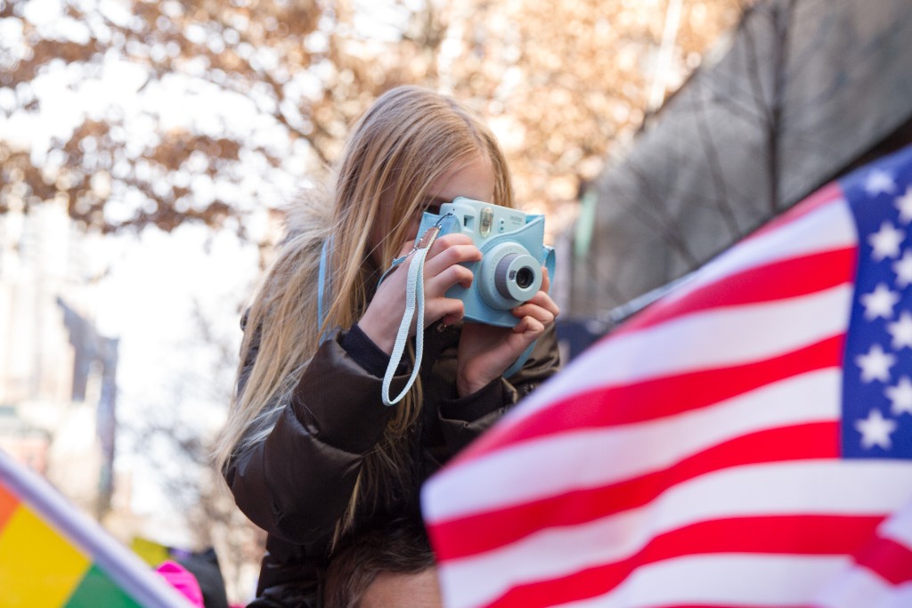 A girl takes photos at a women's event in New York
