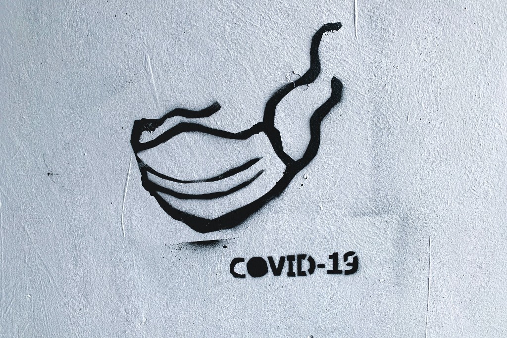 Street art depicting a facial mask on the wall.