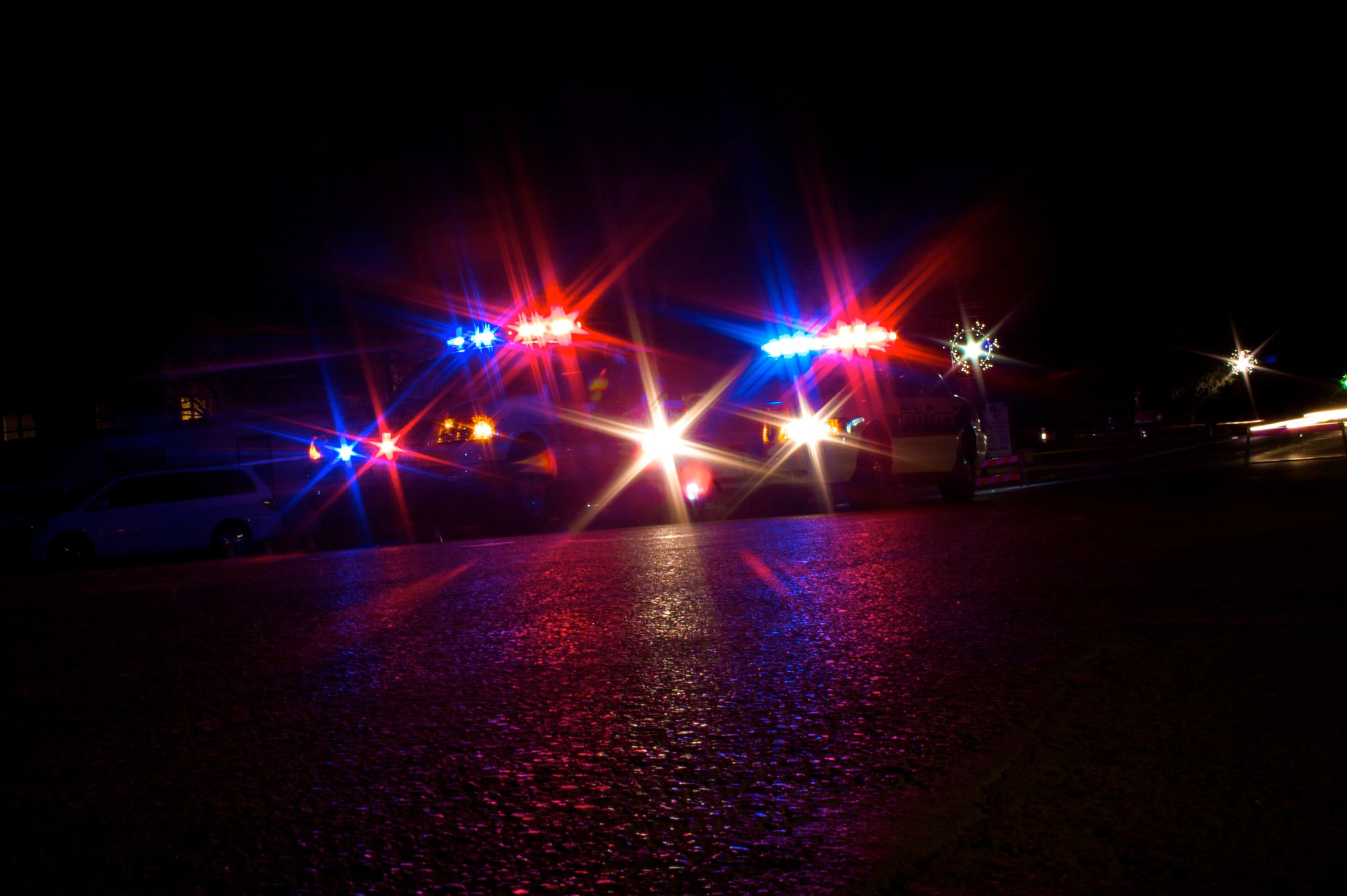 Photo of police car lights at night.