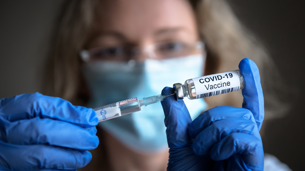COVID-19 vaccine in researcher's hands