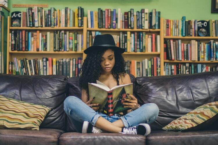 A woman reads a book in a bookstore